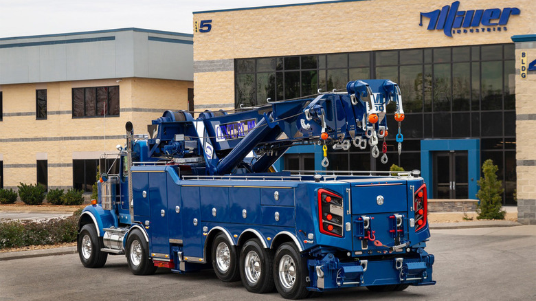 A blue Century M100 tow truck