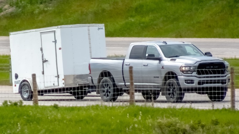 A gray Dodge Ram hauling a trailer