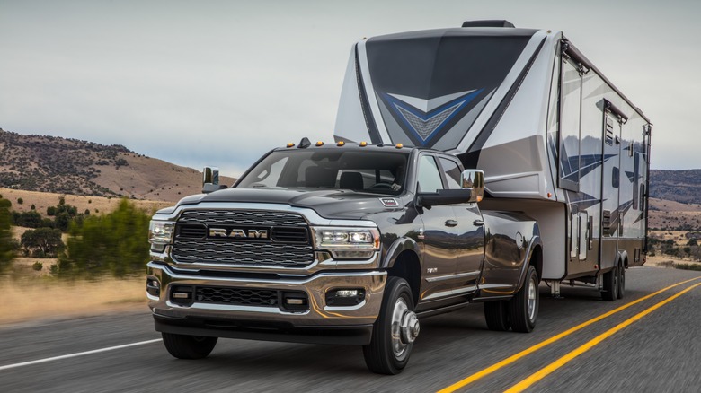 2024 Ram 3500 HD towing a large trailer on an open road