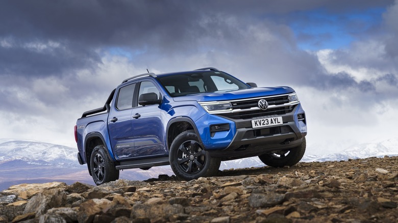 Blue 2024 Volkswagen Amarok parked on a rocky surface