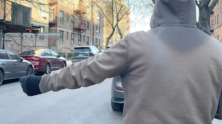 Photo of the motorcycle hand signal for a comfort stop.