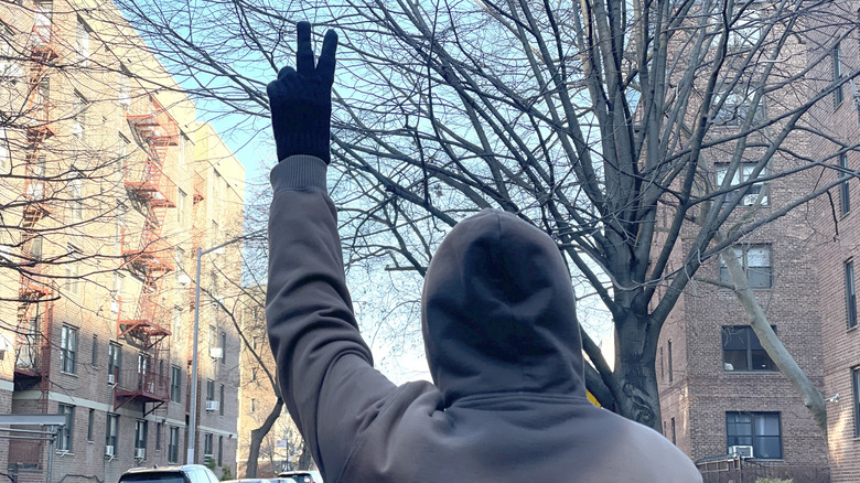 Photo of the motorcycle hand signal for riding double file.