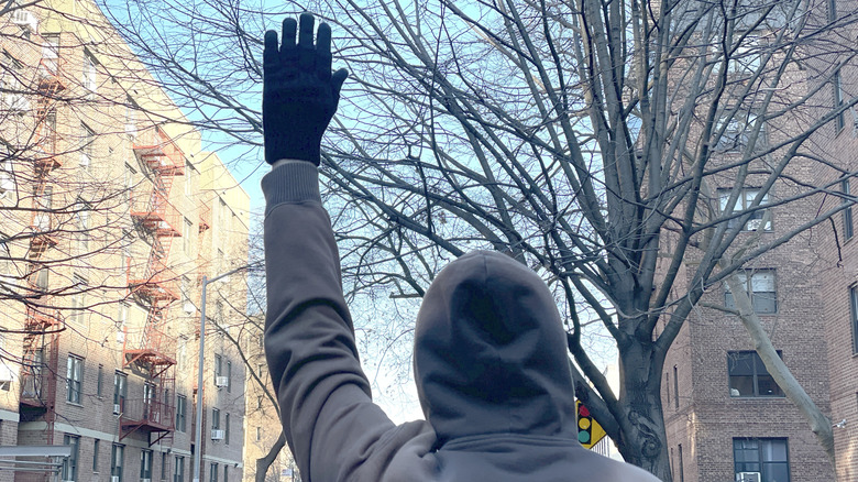 Photo of the motorcycle hand signal for "follow me."