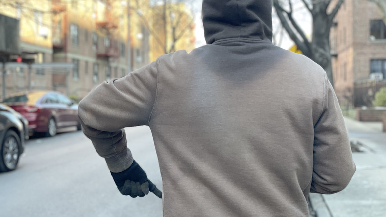 Photo of the motorcycle hand signal for a fuel stop.