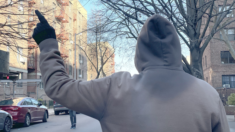 Photo of the motorcycle hand signal for pulling over.