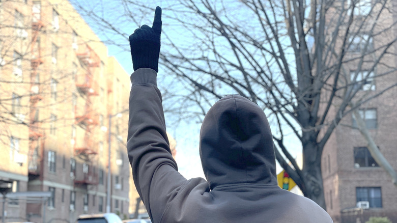 Photo of the motorcycle hand signal for riding single file.