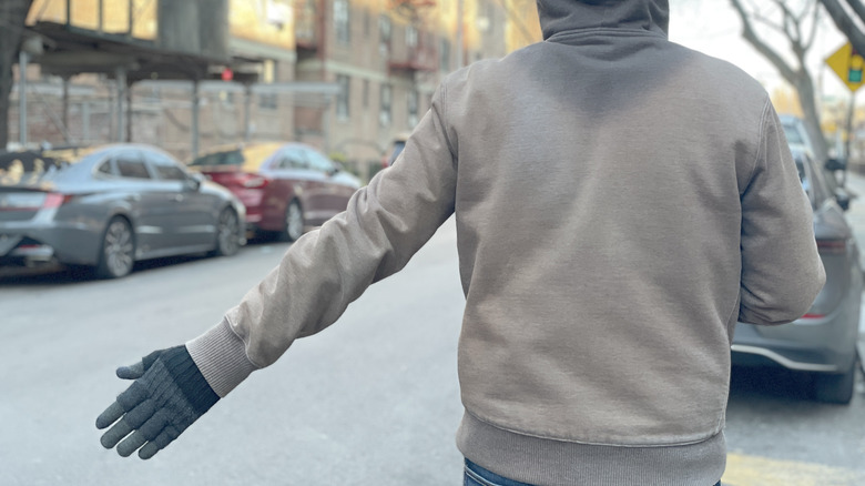 Photo of the motorcycle hand signal for requesting that someone lead.