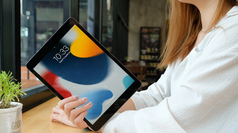 woman holding iPad