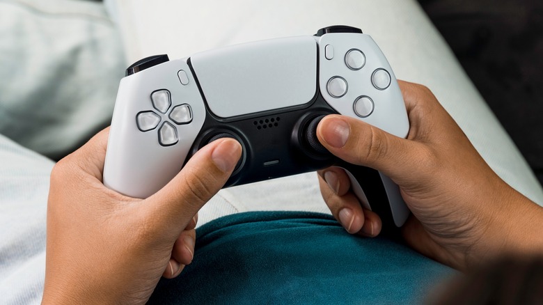 player holding onto DualSense controller