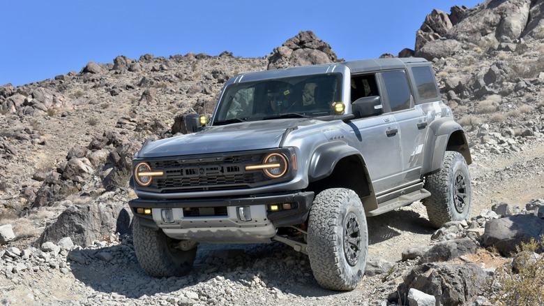 2022 Ford Bronco Raptor driving down a hill.