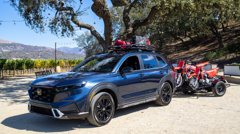 2023 Honda CR-V Hybrid parked with motorcycle trailer