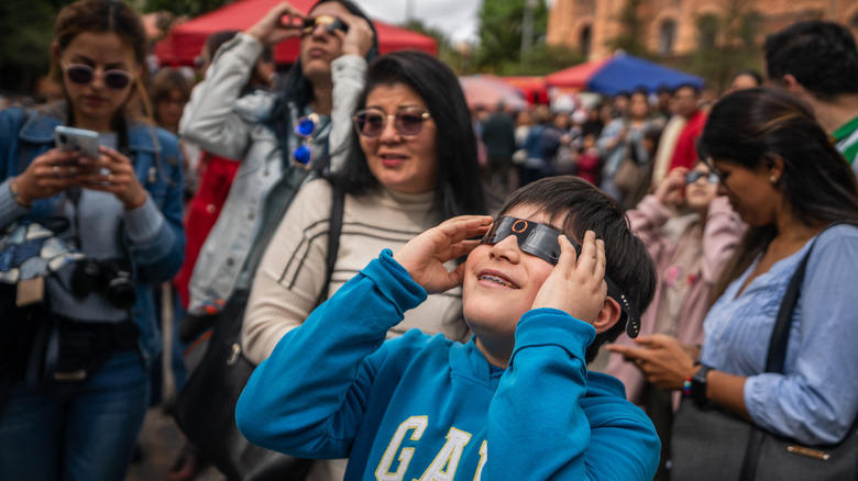 Child using glasses to view a solar eclipse