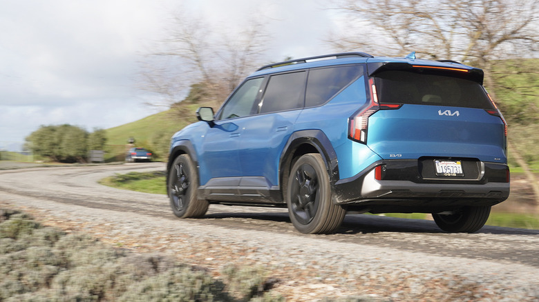 Kia EV9 rear three quarters on a gravel road