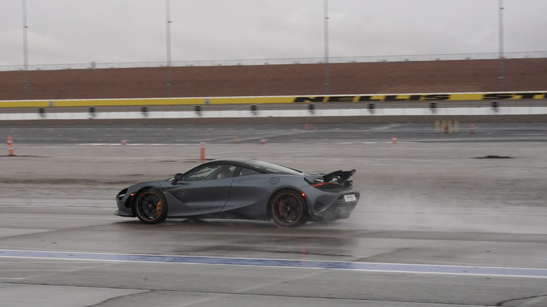 McLaren 750S rear three-quarters on track in the rain