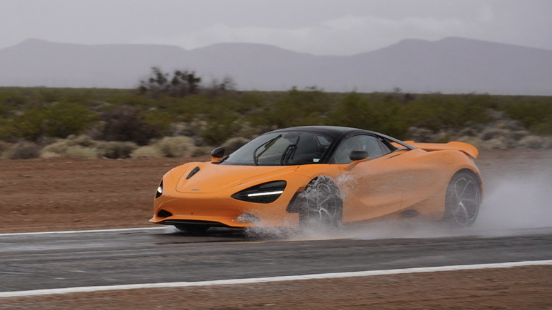 McLaren 750S splashing through puddles in the desert