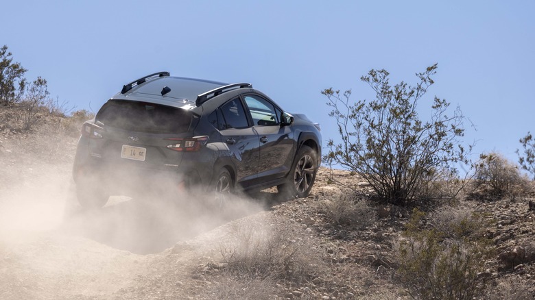 2024 Subaru Crosstrek driving up a dirt hill