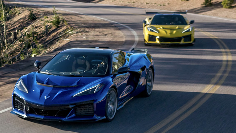 blue and yellow 2025 corvettes driving up road