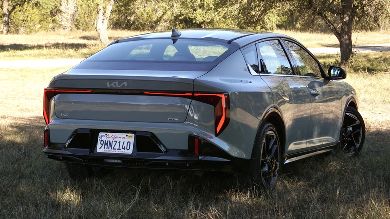 2025 Kia K4 rear 3/4 parked in a field