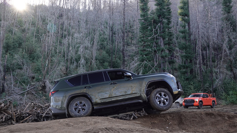 2025 Lexus LX 700h Overtrail in Nori Pearl Green posing with a wheel up