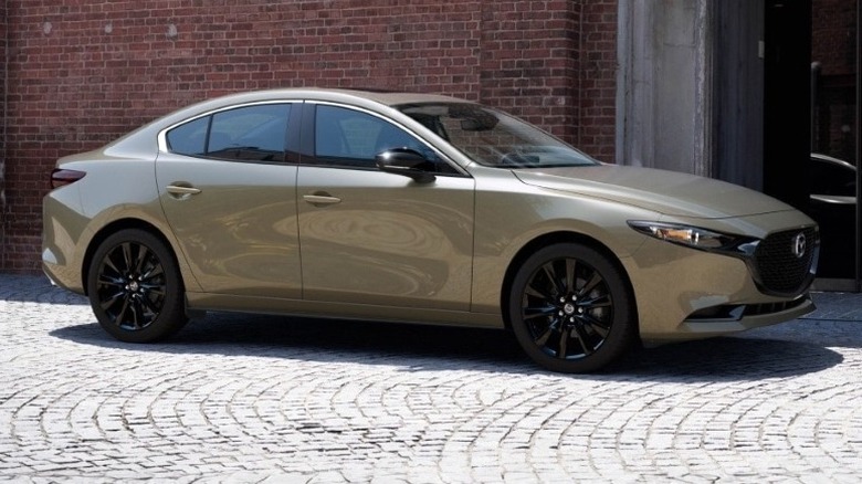 2025 Mazda3 sedan parked in front of a building