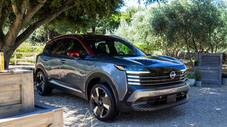 2025 Nissan Kicks SR parked under a tree