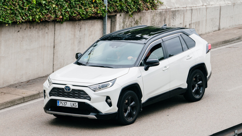 White 2024 RAV4 on road