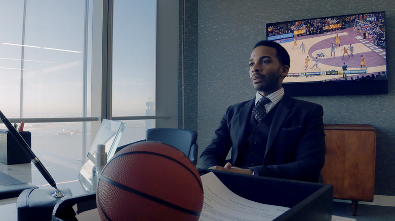 Ray Burke sitting with a basketball on a desk in High Flying Bird