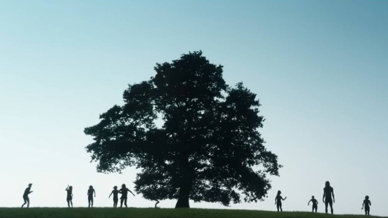 People around a tree in 28 Years Later