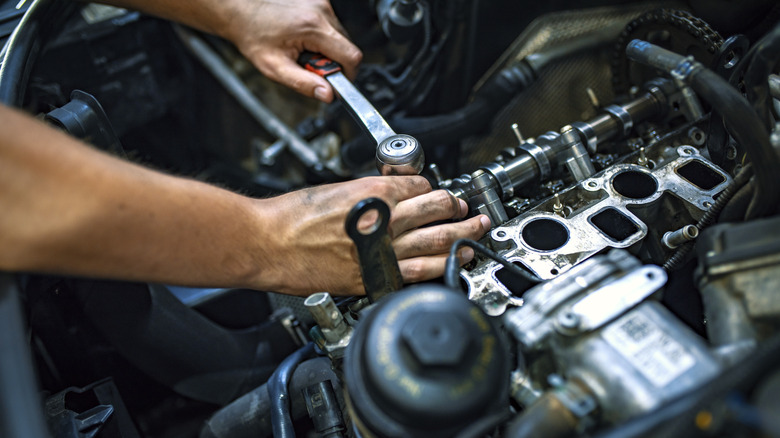 Mechanic working on car engine