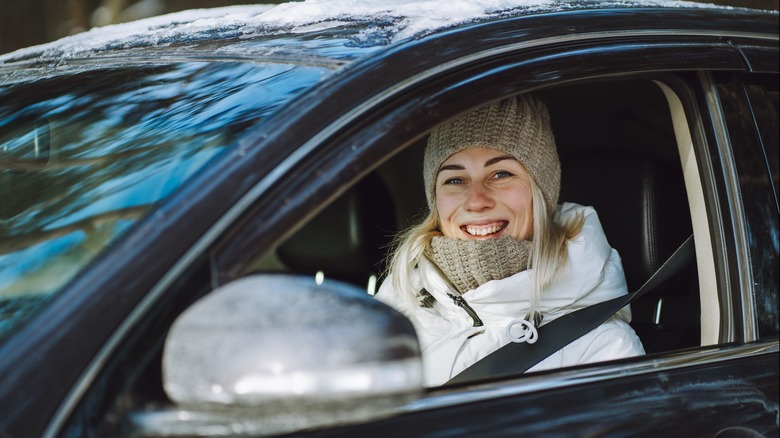 Woman in driver's seat smiling