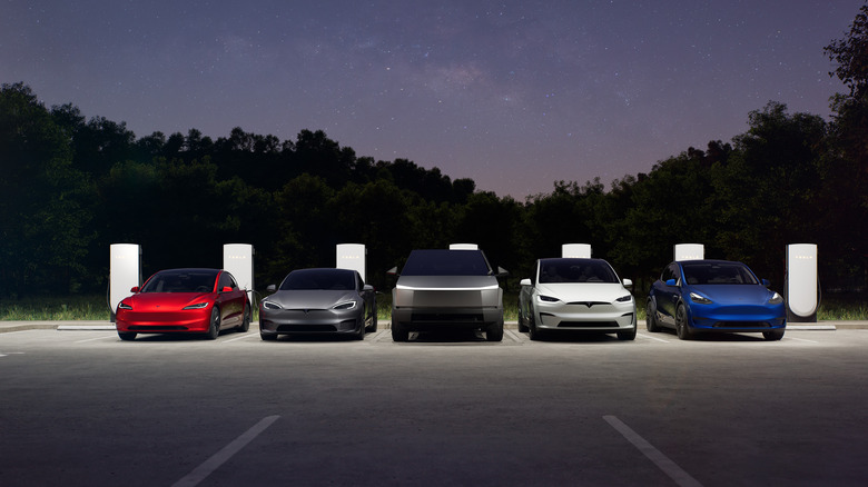 Tesla lineup in parking lot with chargers