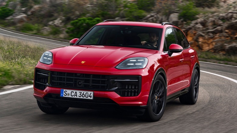 A red Porsche Cayenne GTS on a mountain road