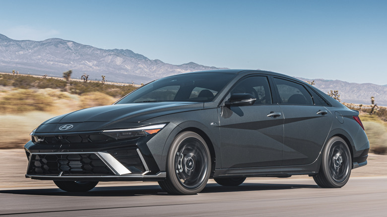 Front 3/4 view of Hyundai Elantra N Line driving on desert road