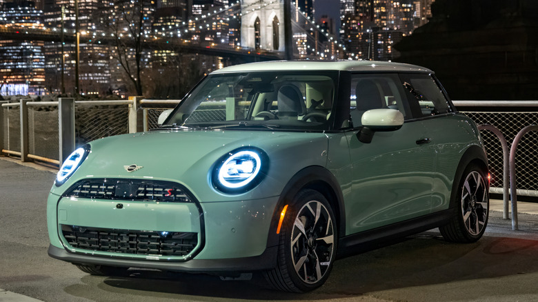 Front 3/4 view of MINI Cooper S 2-Door parked by water in front of bridge