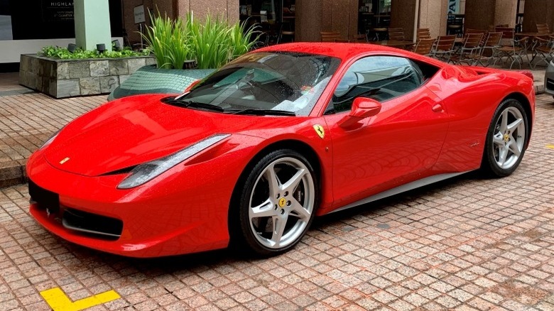 Red Ferrari 458 Italia parked in front of a building