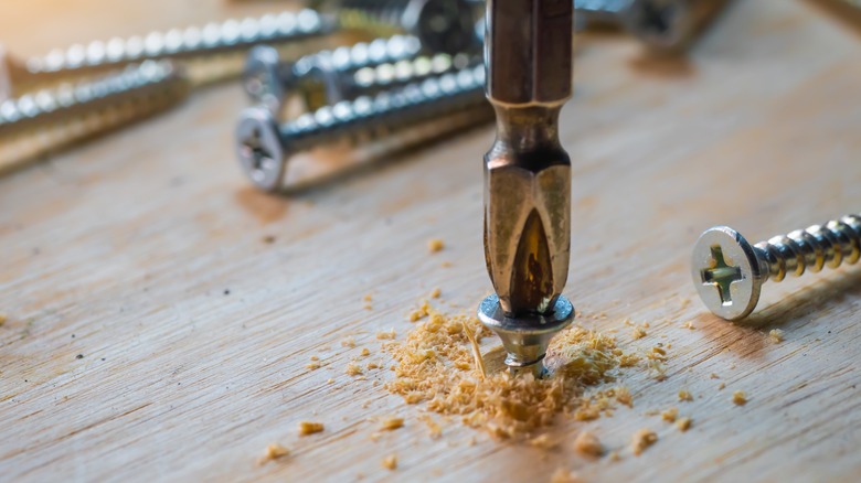 Drilling a screw into wood