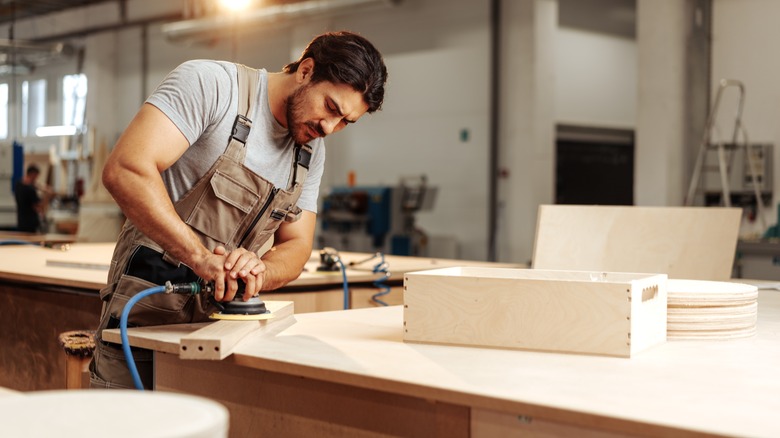 woodworker with sander