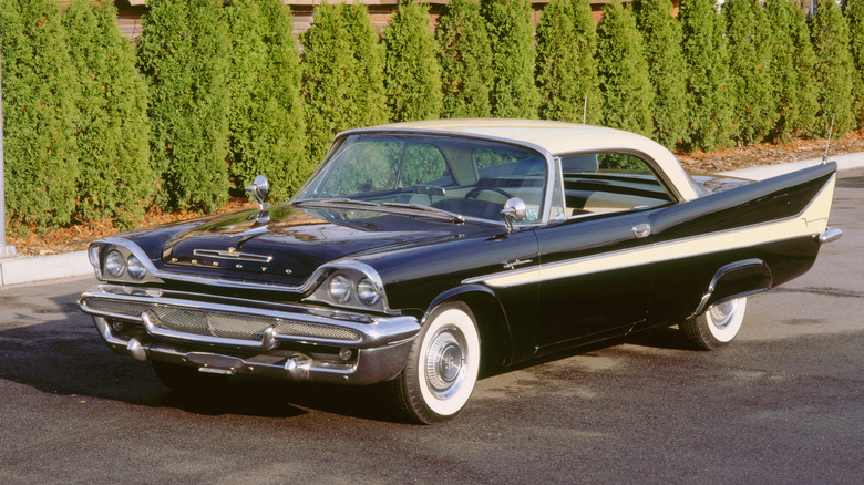 Black 1958 DeSoto Sportsman with trees in background