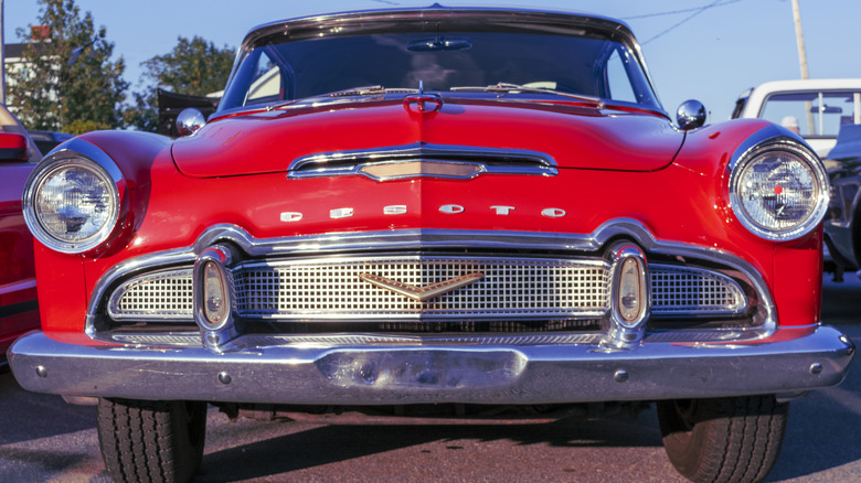 A red De Soto at a classic car show