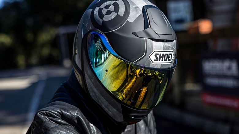 A motorcycle rider wearing a Shoei Neotect II helmet