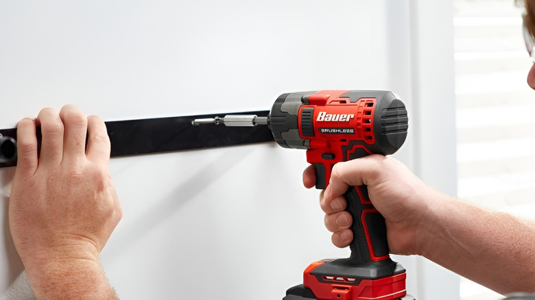 Man using BauerImpact driver on their wall