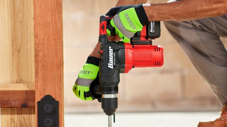 Man using rotary hammer in construction