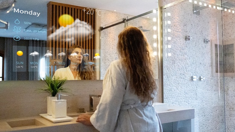 woman looking in smart mirror