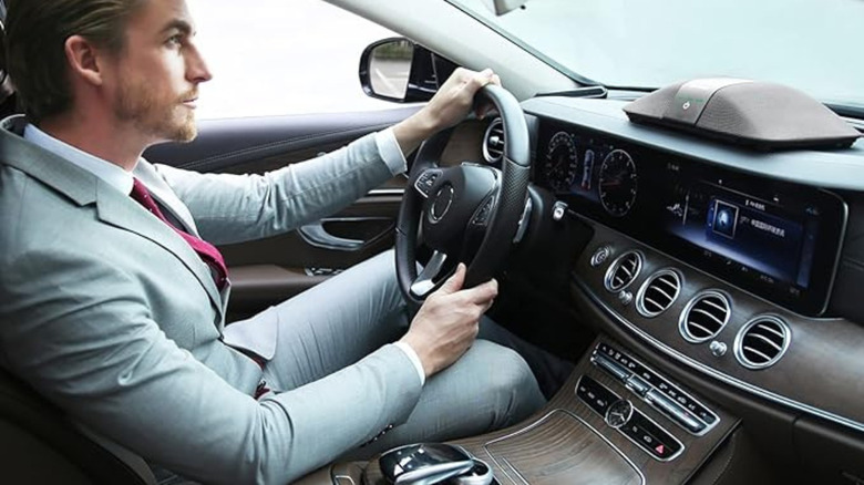 Man driving with air purifier on vehicle dashboard