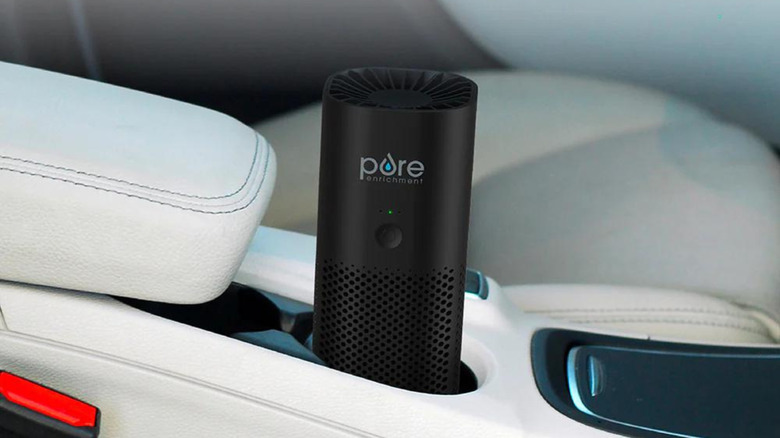 Air purifier sitting in a car's cup holder