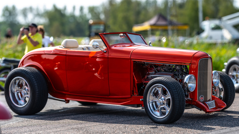 A red Ford Roadster at a car show.