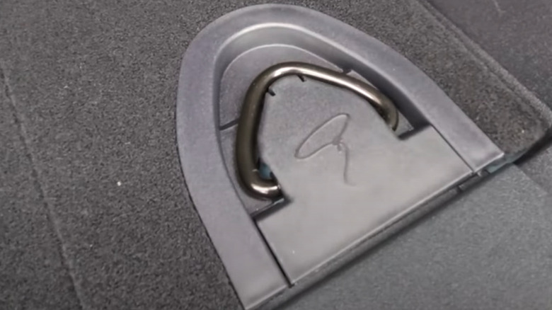 Lasso symbol on the rear tie-down loops inside the Ford Bronco's trunk.