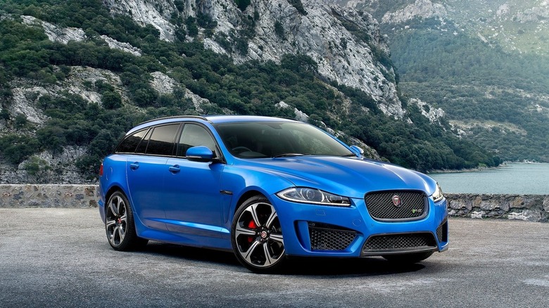 Blue Jaguar XFR-S Sportbrake, front 3/4 view, mountain lookout point