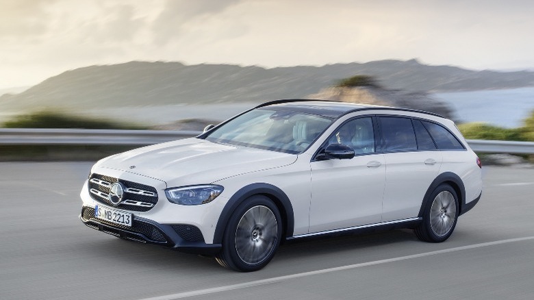 White Mercedes-Benz E450 All-Terrain driving, front 3/4 view 