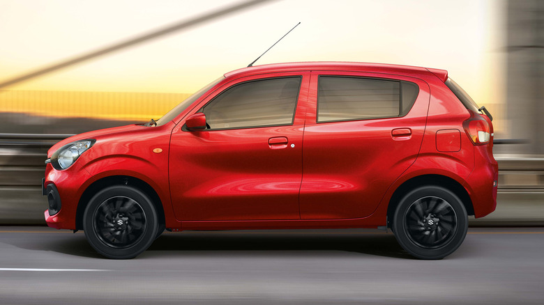 A red Suzuki Celerio on the street.